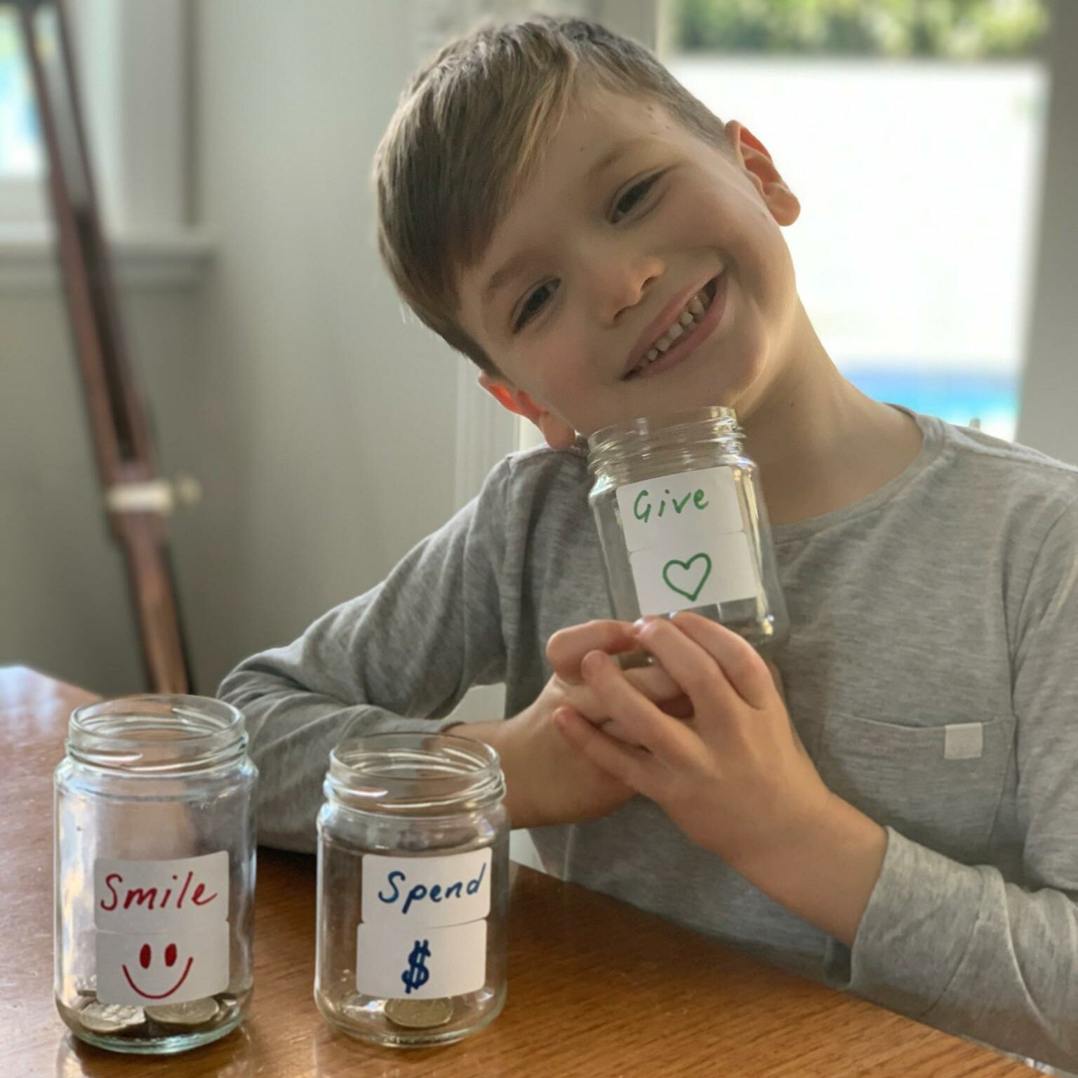 Max with his savings jars