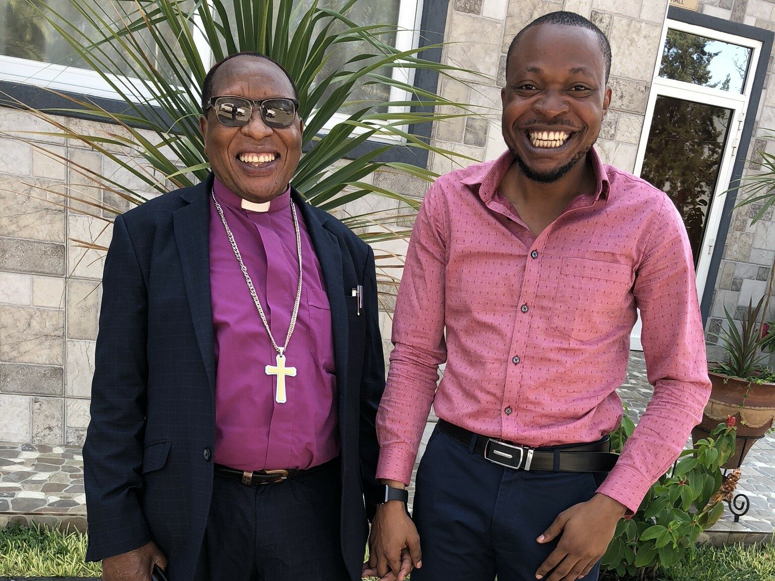 Dr Lévis Milegha Mbala (on the left) standing with WorldShare's former International Partnerships Director Blaise Itabelo during a partnership visit in 2018.