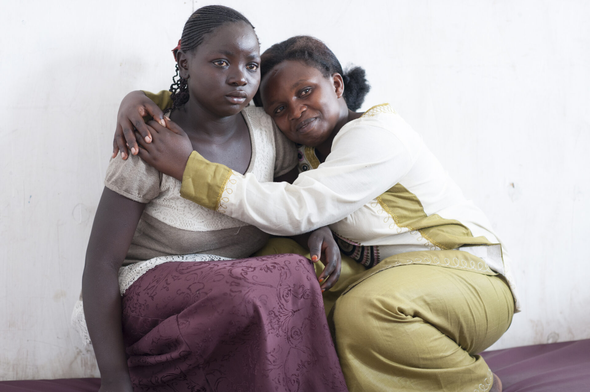 One woman hugs a crying woman in a sign of compassion and care.